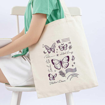 Tsuki ‘Flutter + Dream’ Tote Bag by Notebook Therapy x Pelinkan on model’s arm in light grey background